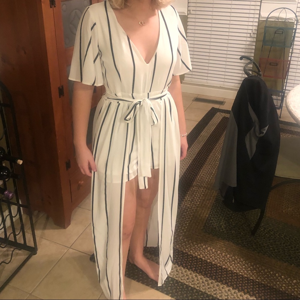 Off white romper with black stripes with a train